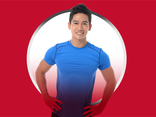 Smiling young man standing confidently and wearing blue T-shirt, happy after Canesten jock itch treatment