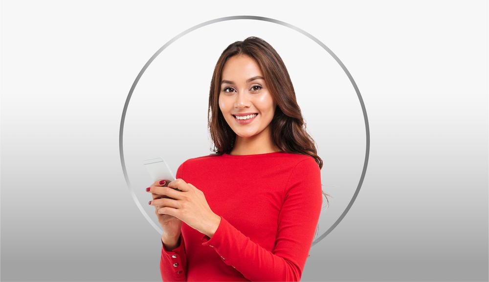 Smiling young woman with dark hair wearing red T-shirt flexing